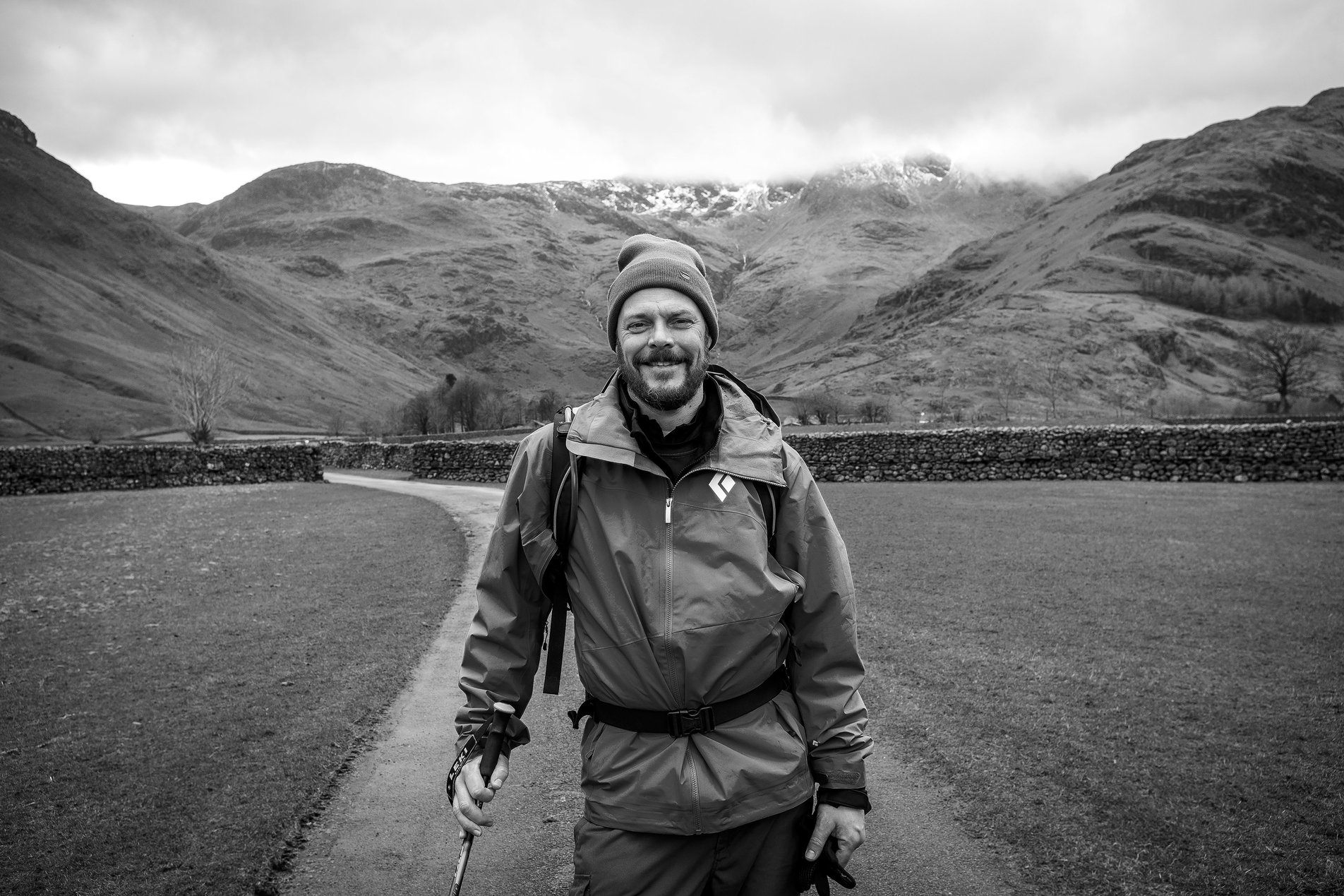 hiker walking towards camera in mountain landscape