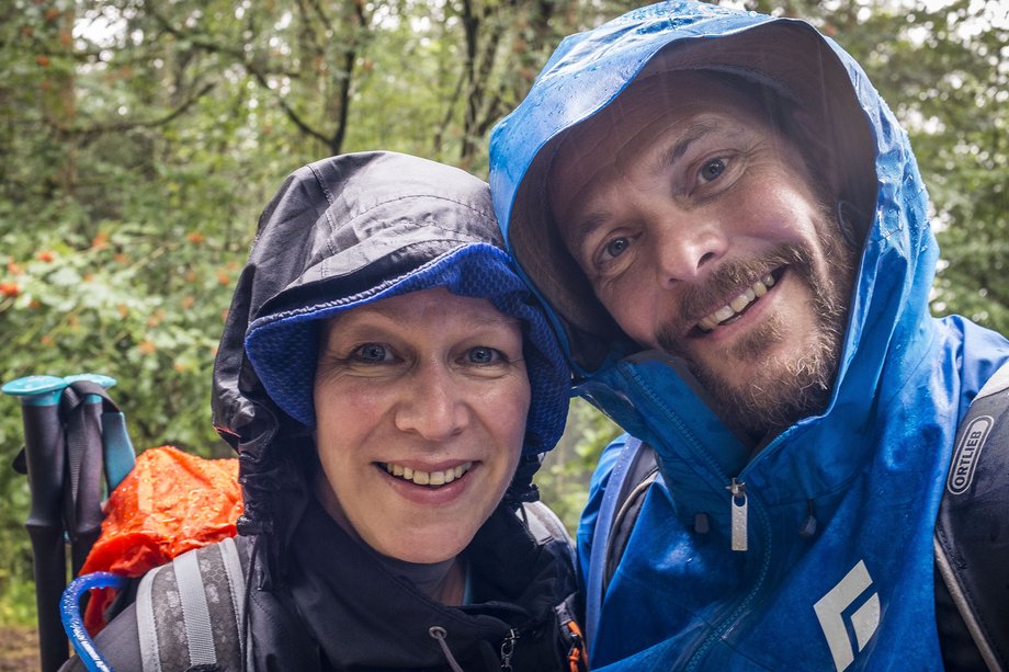 selfie picture of 2 hikers in the rain