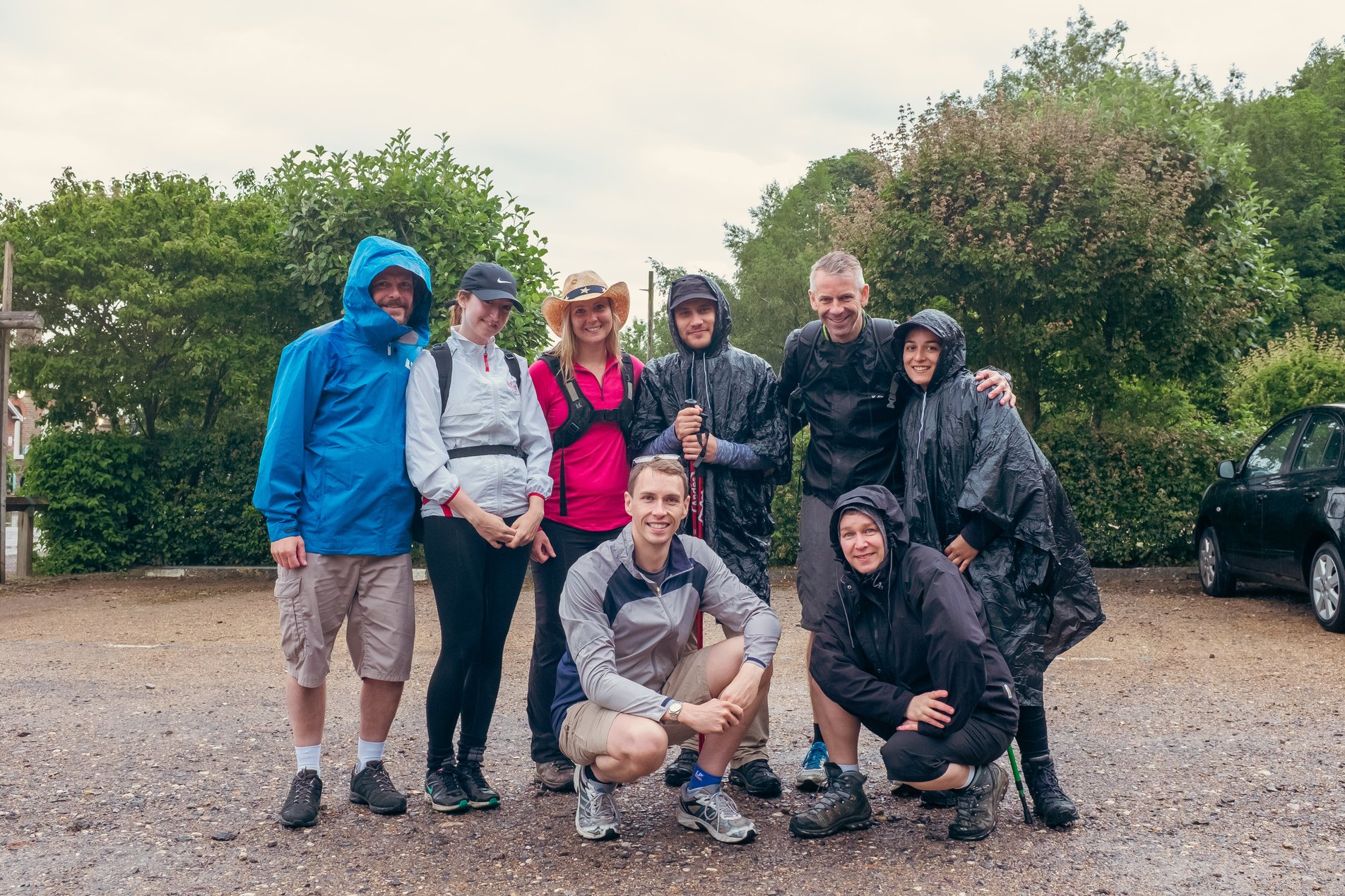 team shot of hikers in car park