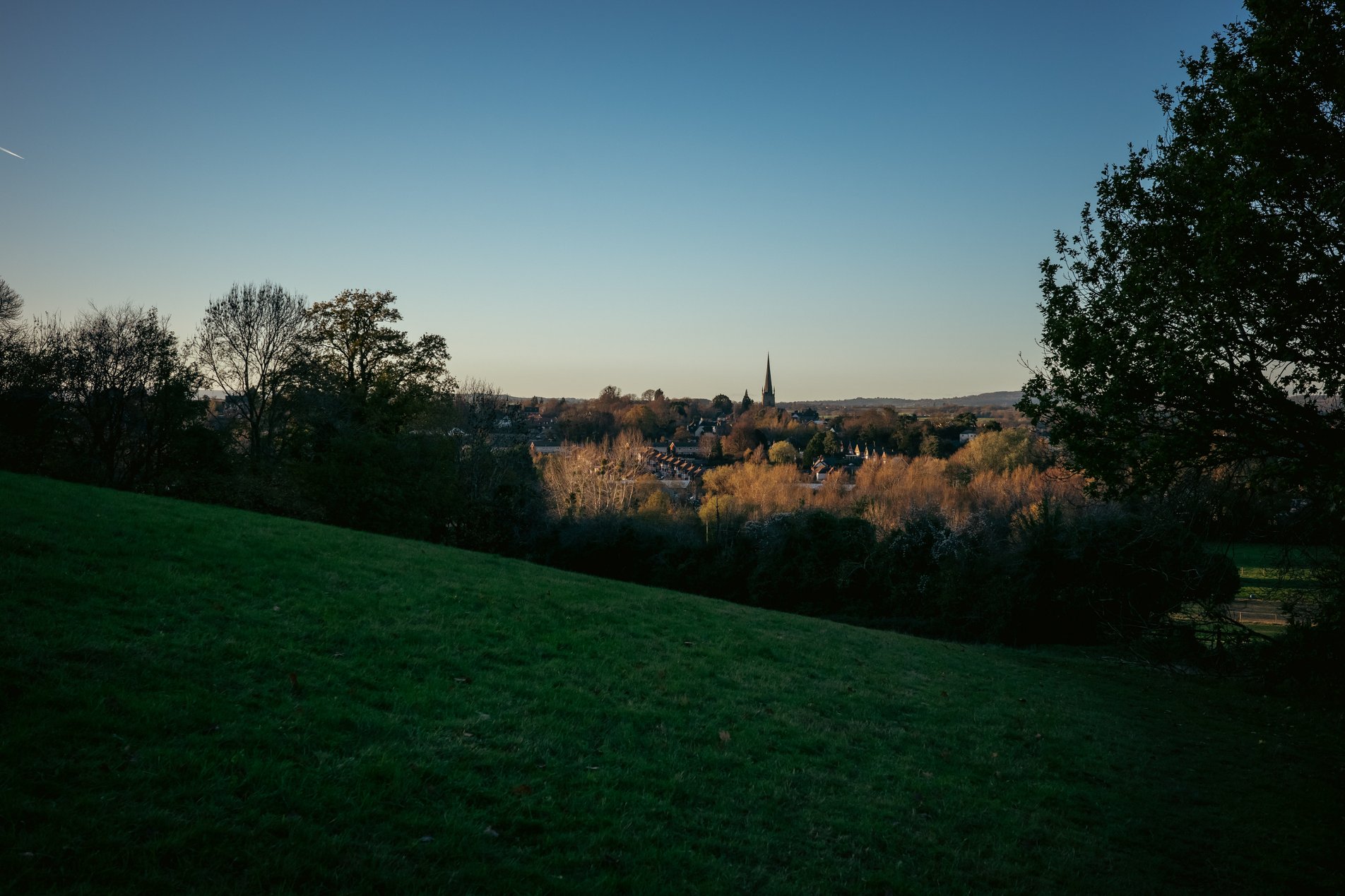 view over fields to ross-on-wye in evening winter light