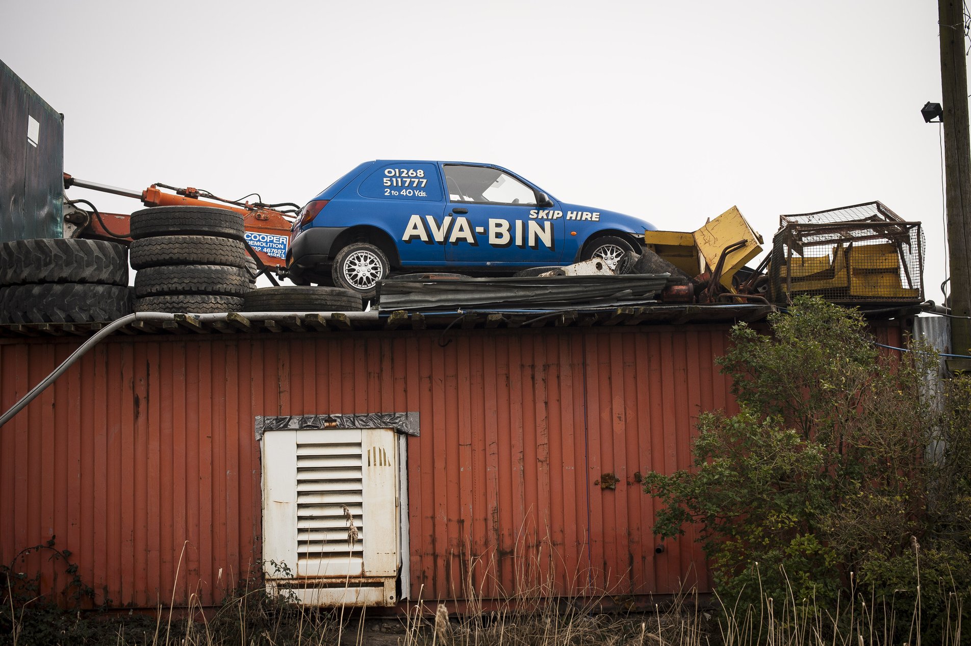 signwrittten car on top on shed