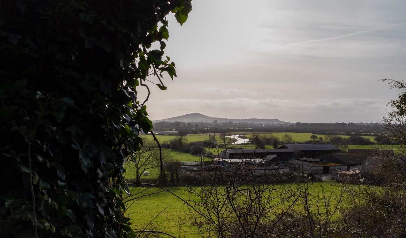 farm buildings, river and hill