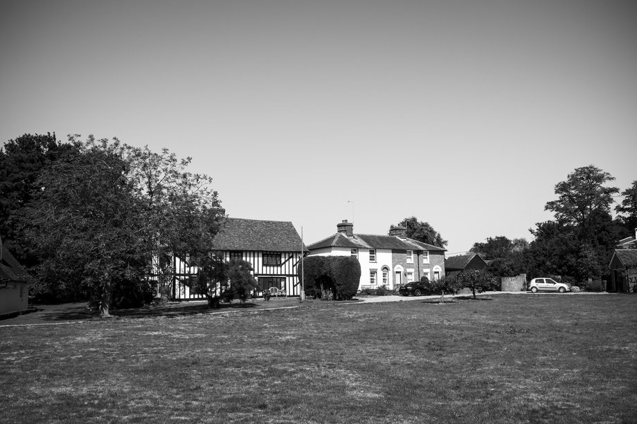 houses on green, one with tudor beams