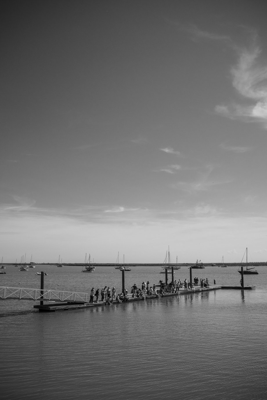 people sitting on jetty in summer