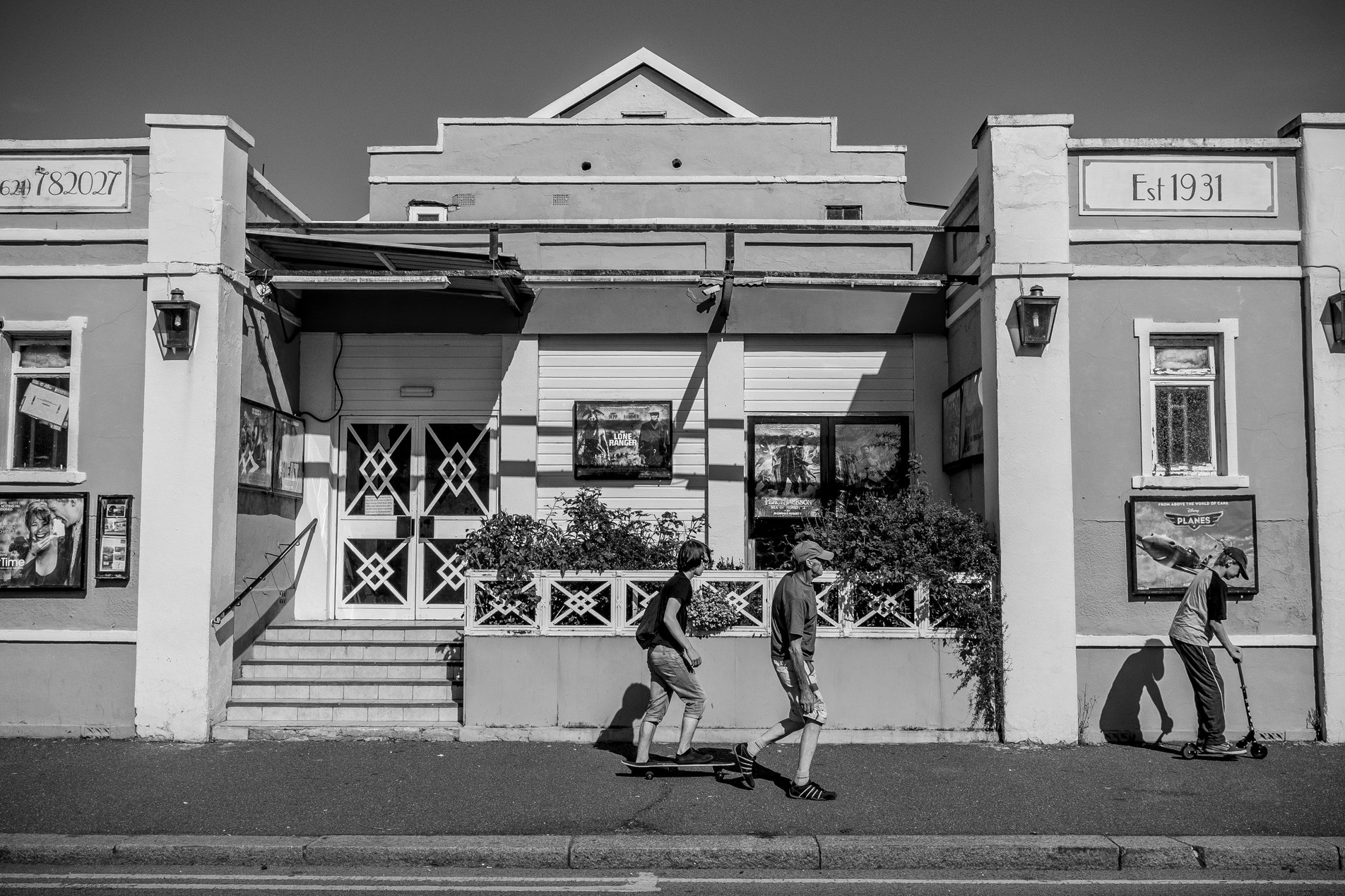 art deco cinema building with people walking past