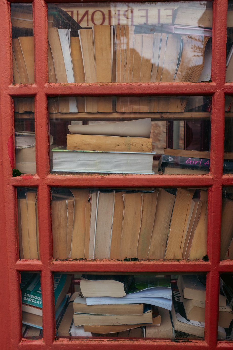 books stacked in a red telephone box