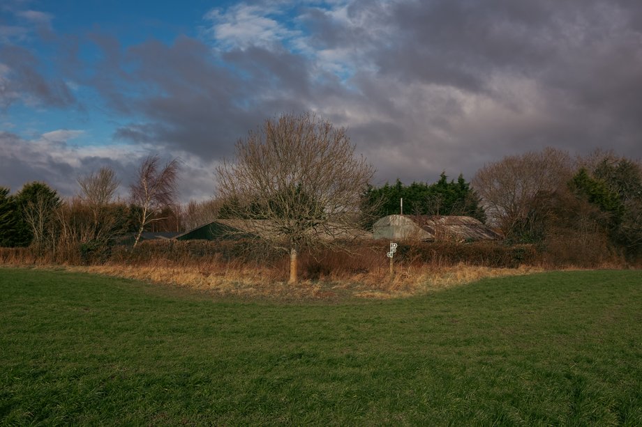 field with footpath markers on post