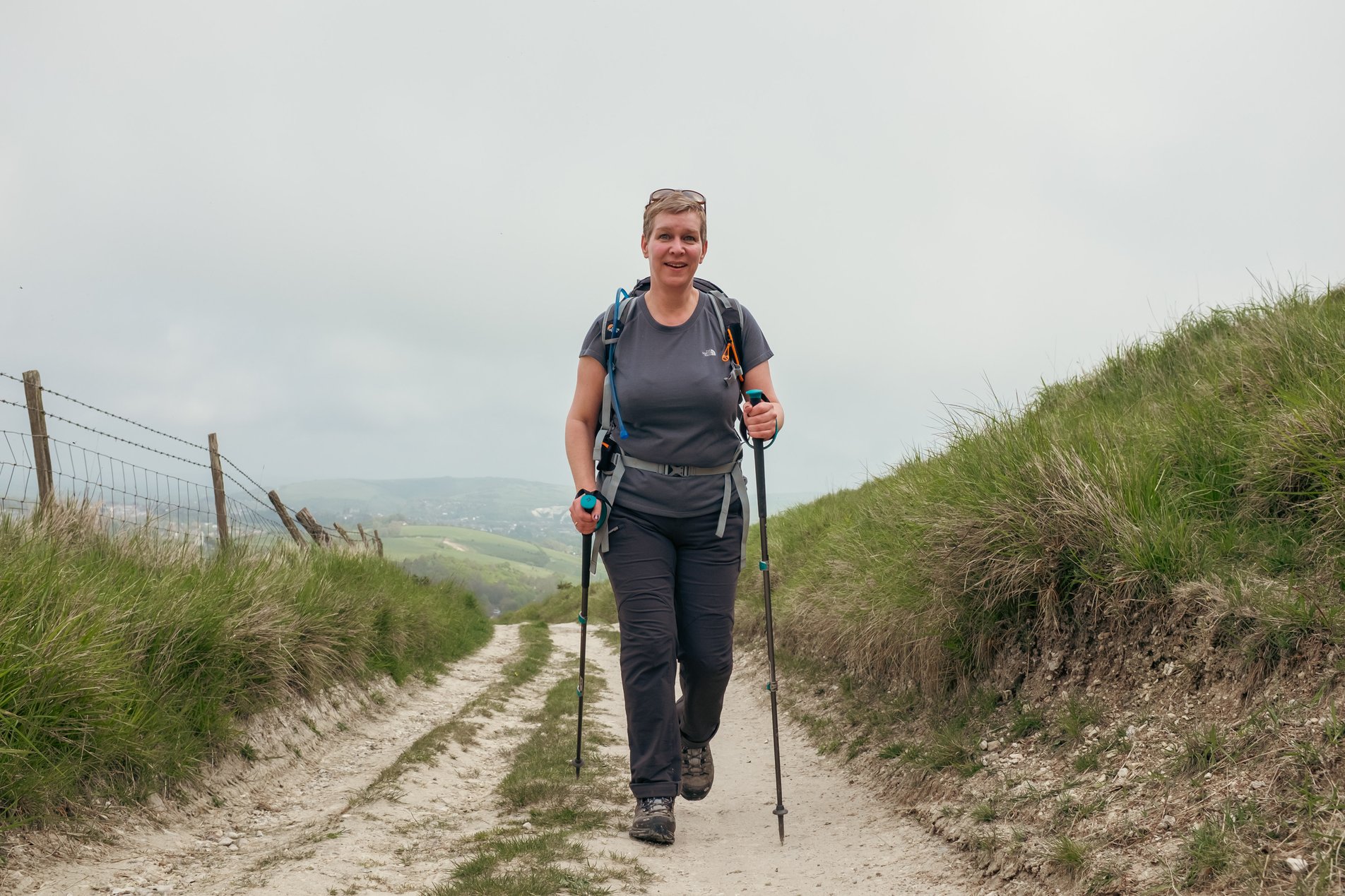hiker with poles on chalk track