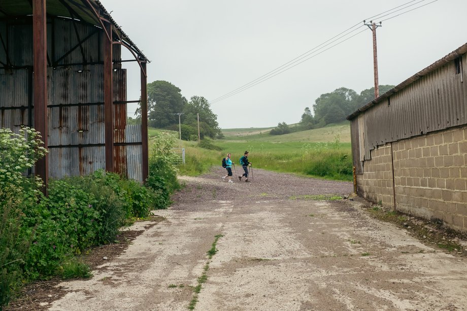 walkers on path through farm