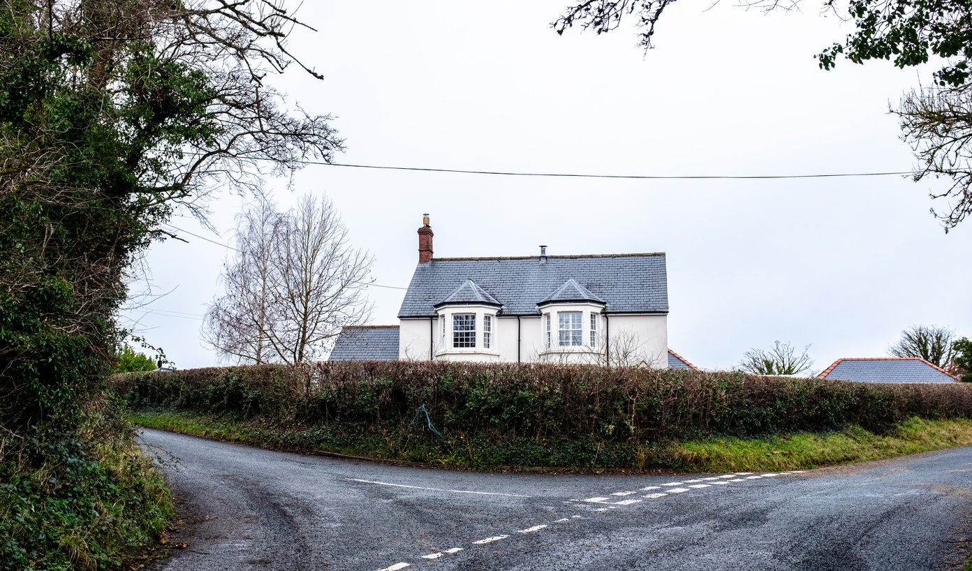 road junction with white house
