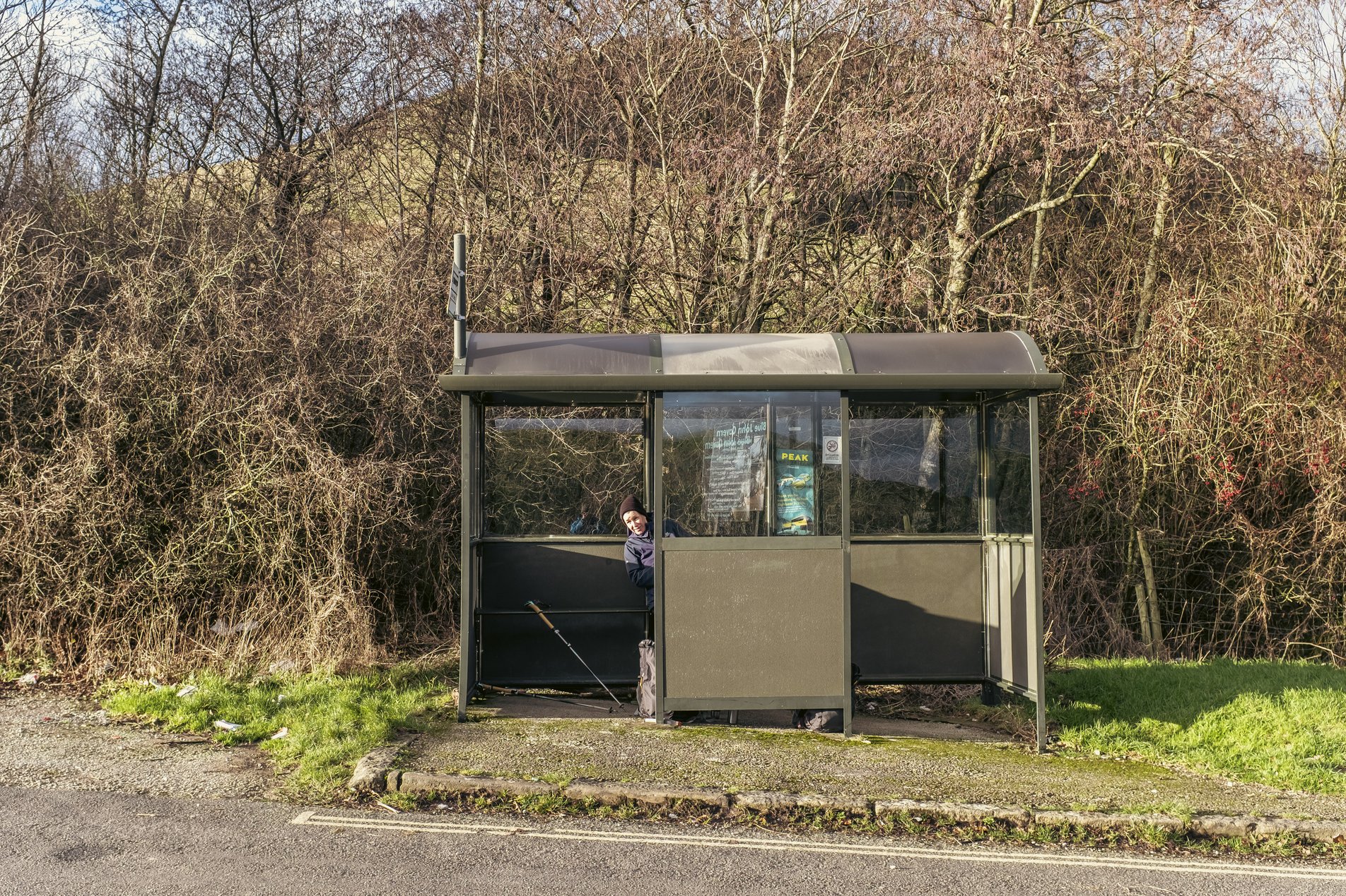 hiker in bus shelter