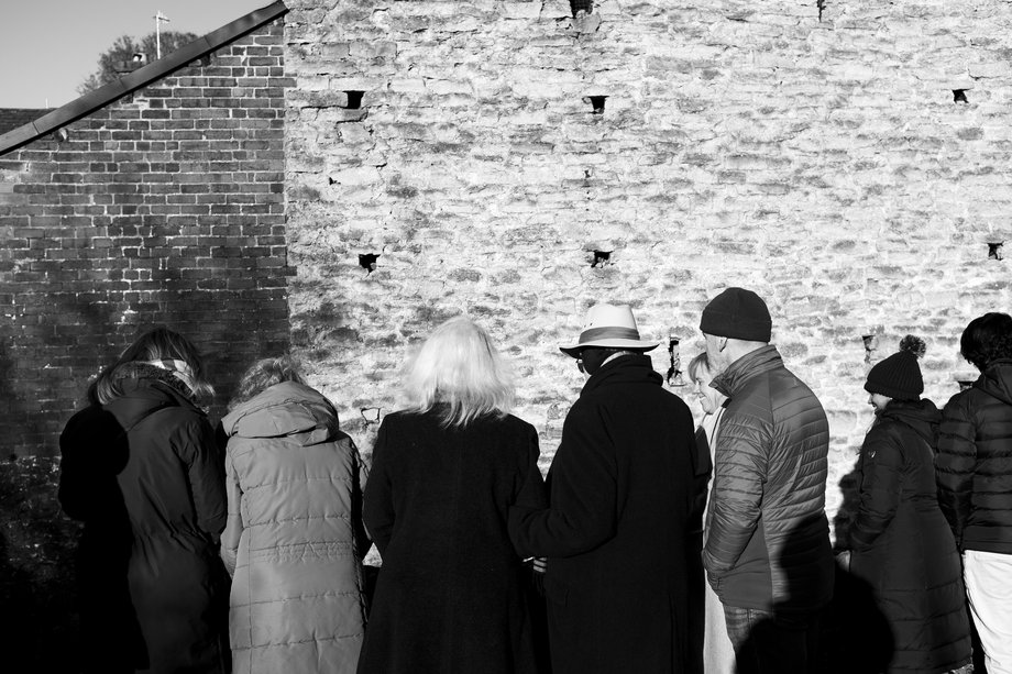 backs of figures standing in a line