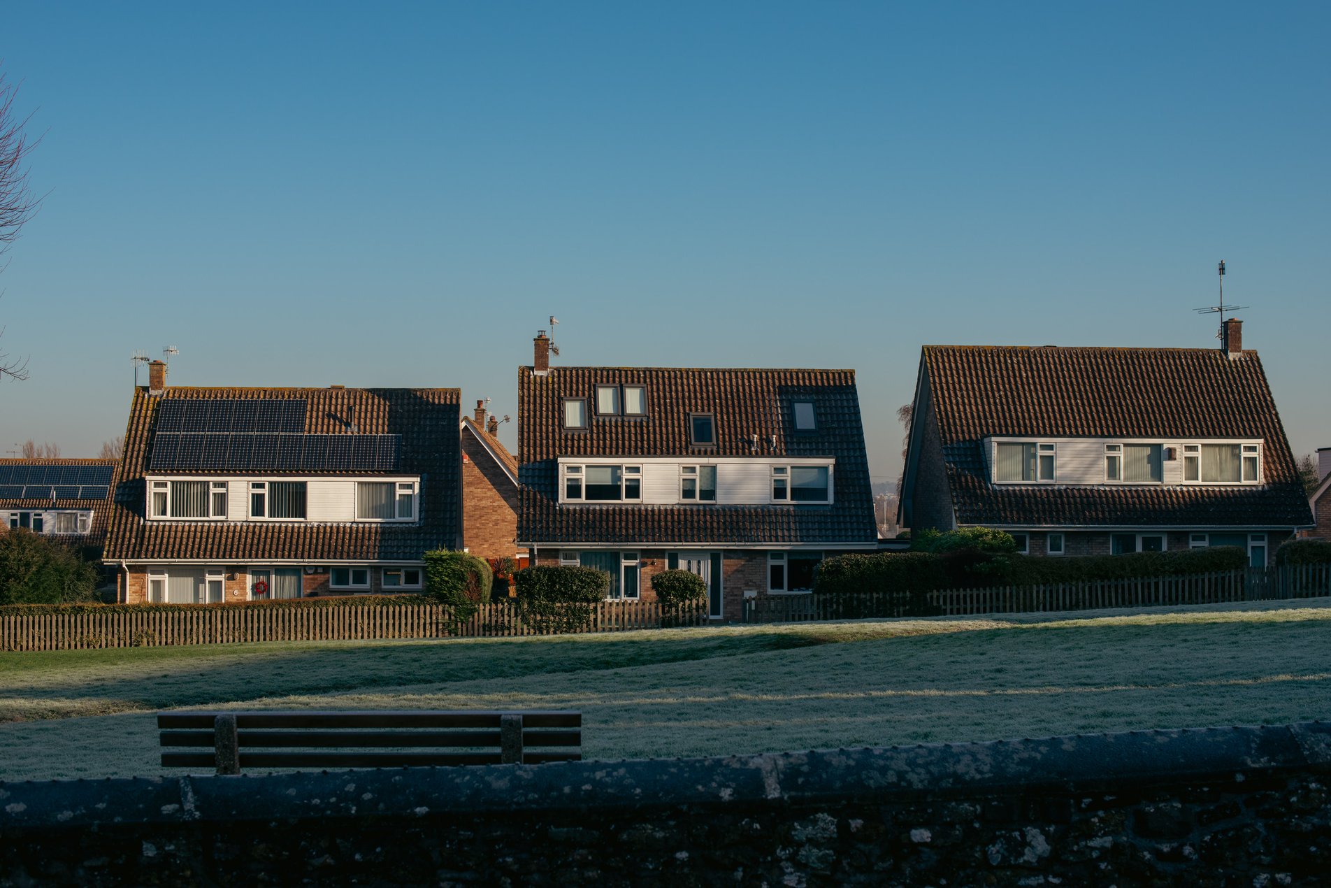 1970s houses with sloped roofs on frosty green