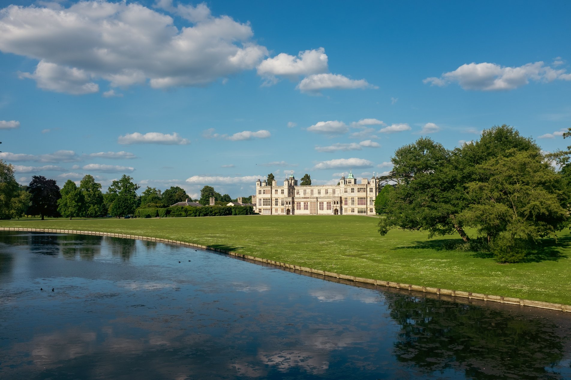 english country house seen across lake