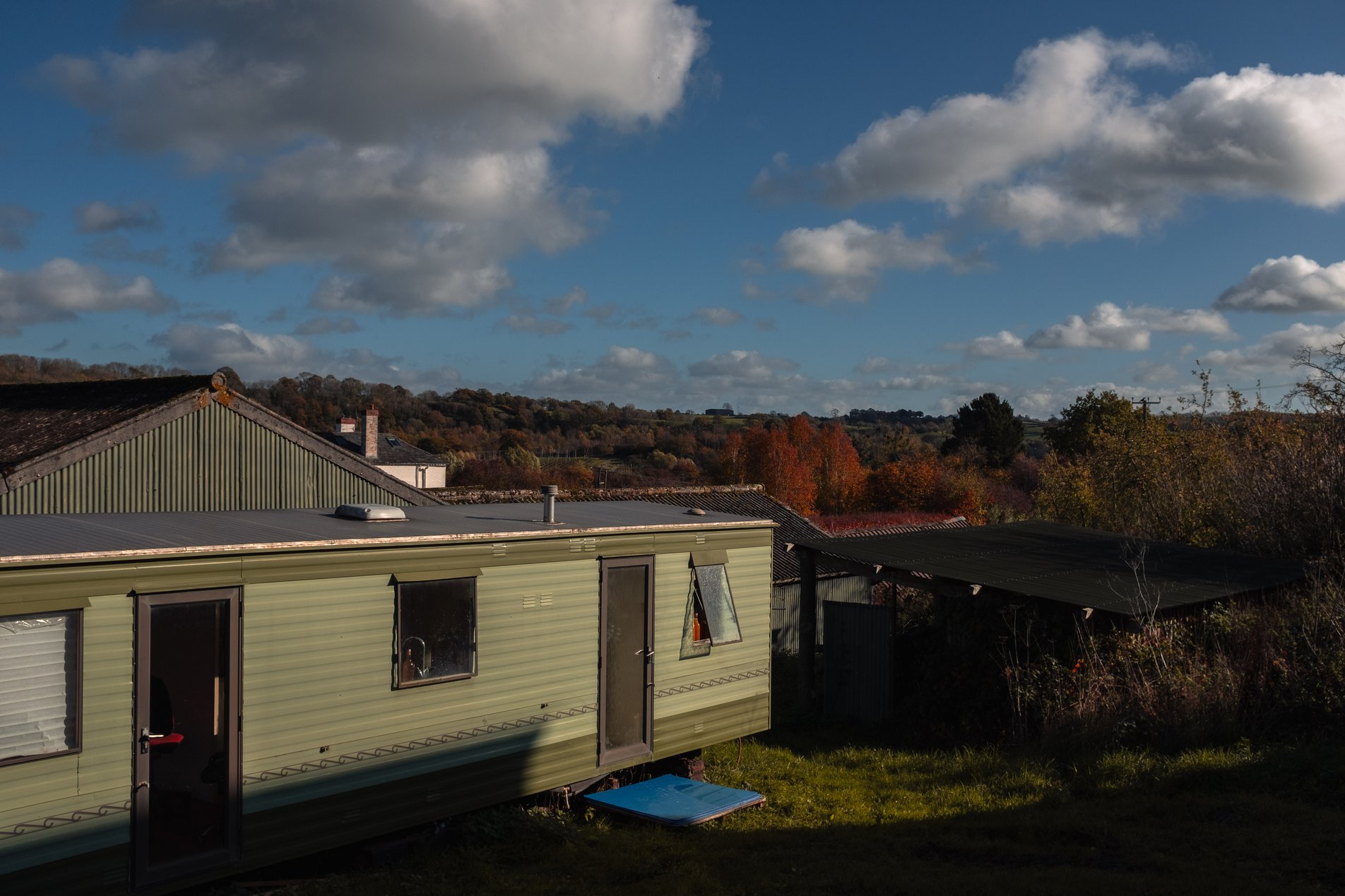 green static caravan on farm