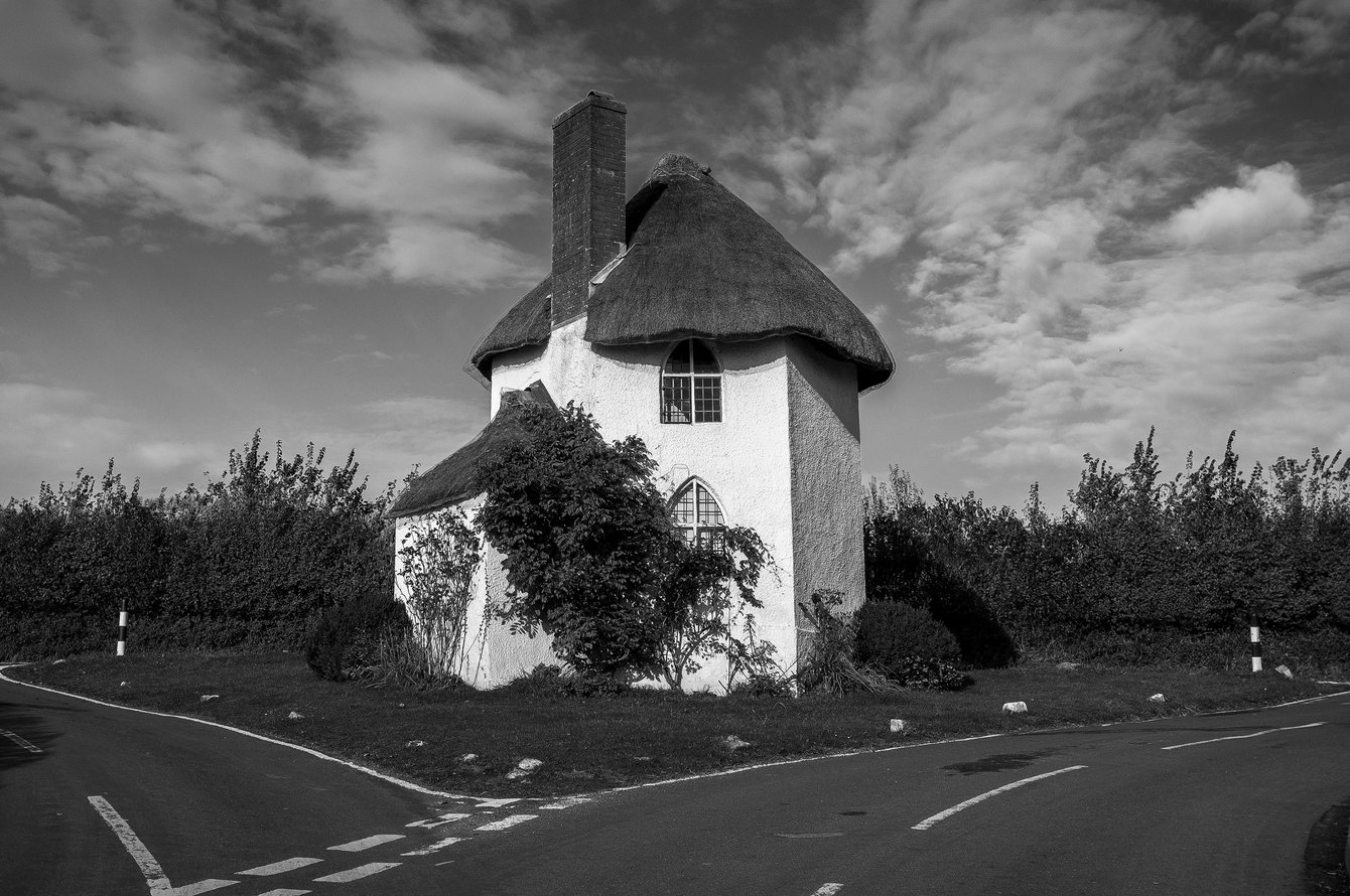 Small white thatched cottage on road island
