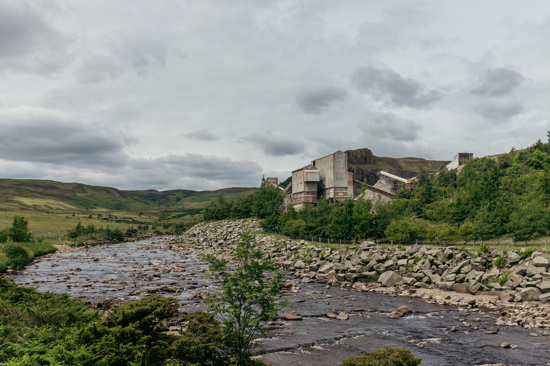 river alongside stone quarry buildings