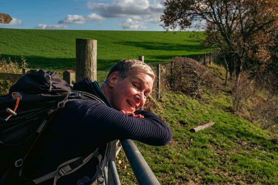 hiker resting on gate